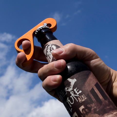 Pops caps with a one-handed grab.  It's a bottle opener that keeps caps flat.  Making it perfect for bottle cap collectors.